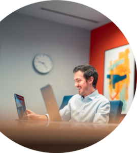 Person smiling on a video call in a conference room