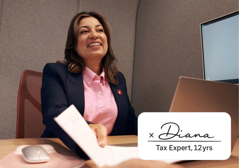 A smiling TurboTax tax expert seated at a desk hands a document to a client, with an overlay identifying her as Diana, a tax expert with 12 years of experience.